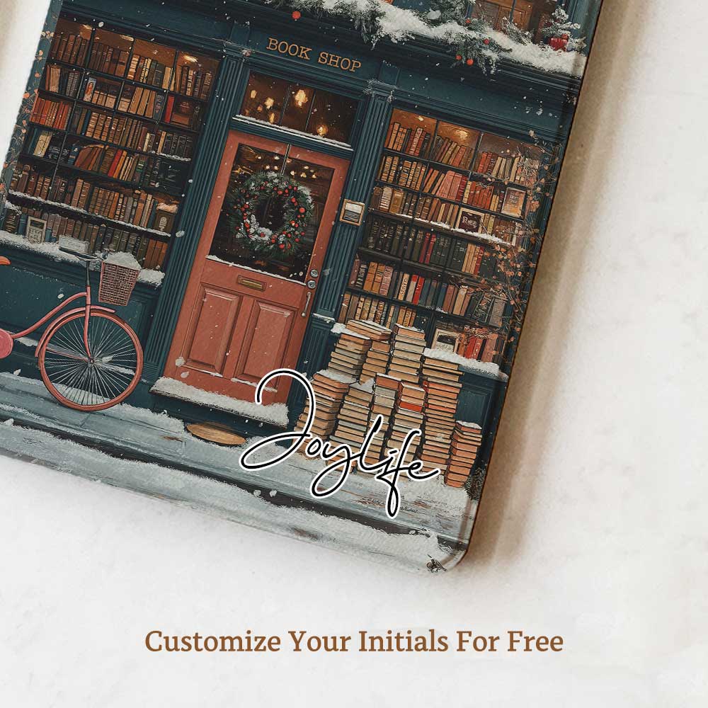 The Kindle case features a snowy bookstore with a red door and a black sign reading "Cherry." The exterior and roof are covered in books, highlighting the book-filled charm of the place. Warm lights glow around the store, and snowflakes gently fall from the sky, creating a peaceful and cozy atmosphere.