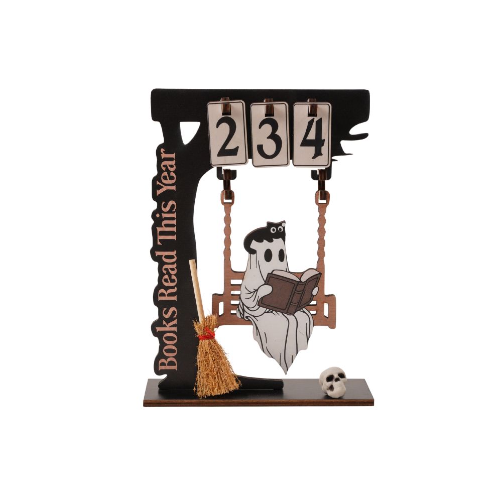 Halloween-themed wooden desk calendar featuring a swing with a ghost reading a book, a broom, a small skull, and a vertical sign reading 'Books Read This Year'. The top flip-days display '234'.