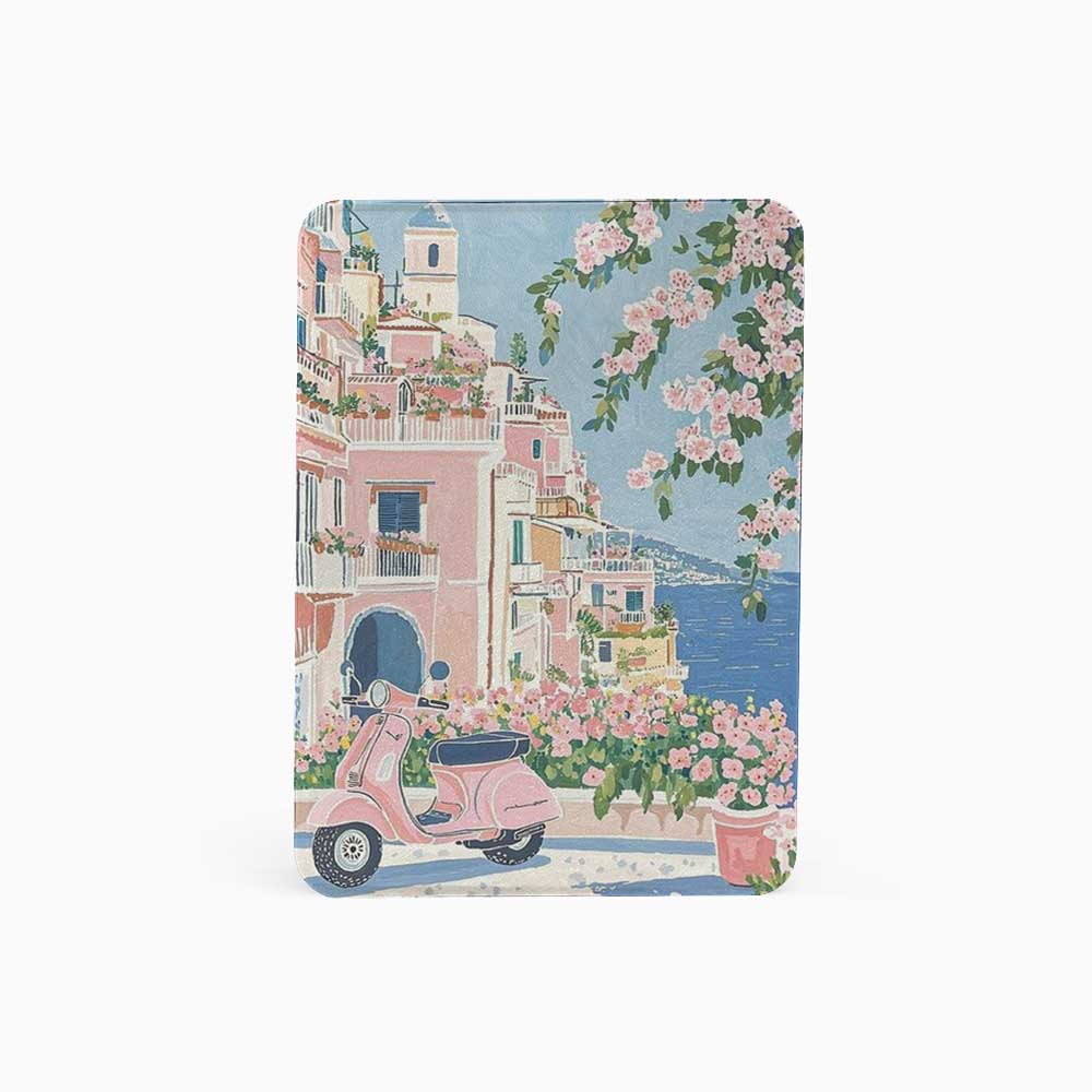 Notebook with a design of a pink scooter, buildings, and flowers on a blue background