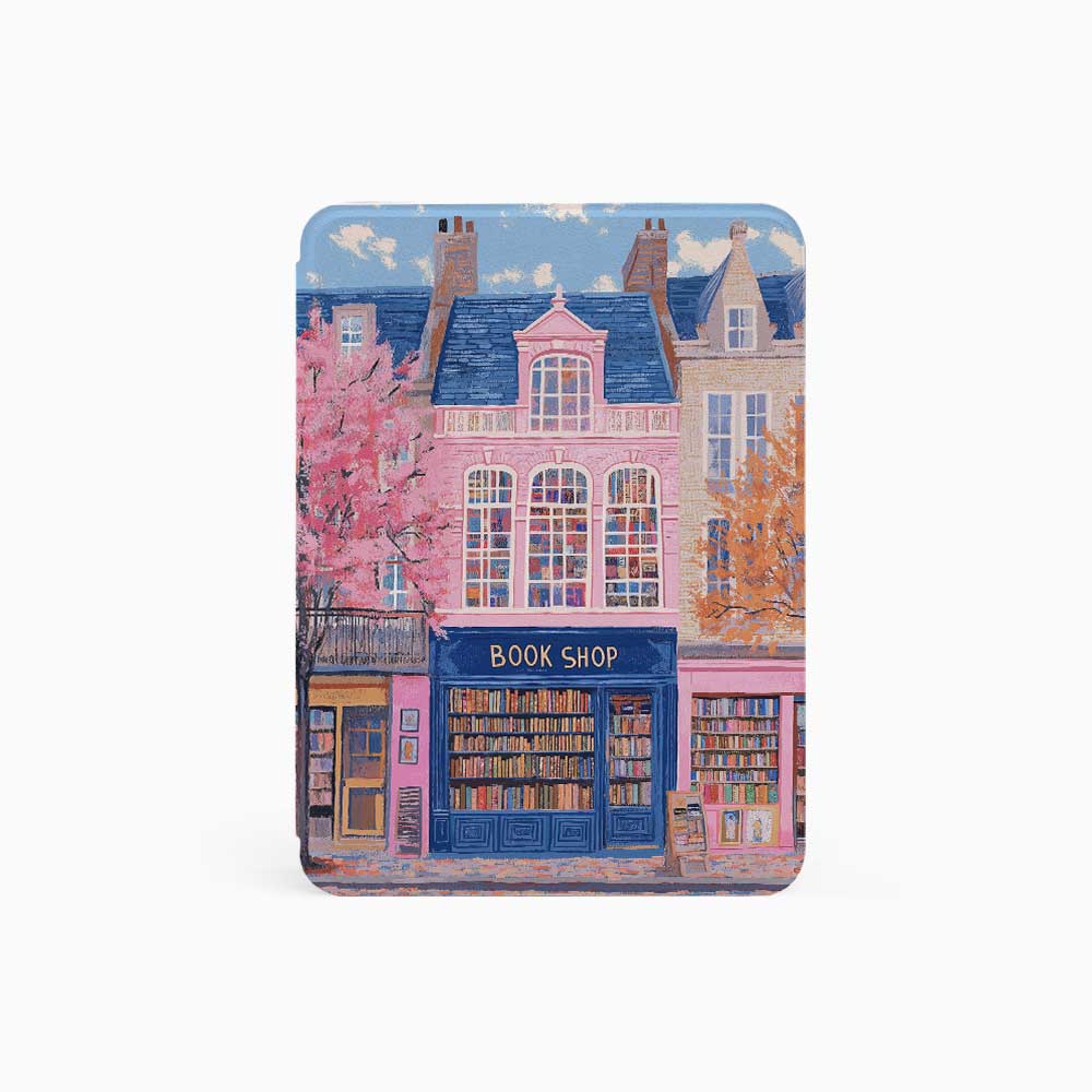 Design for a Kindle softcolor case featuring an illustration of a pink building with a blue roof and white-framed windows. In front, a bookshelf labeled 'BOOK SHOP' is displayed.