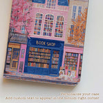 The iPad Pro M4 Case design features an illustration of a city street with vibrant buildings. The most prominent is a pink building in the center, labeled "BOOK SHOP." Large windows on the building display colorful bookshelves, creating an atmosphere full of knowledge and culture.