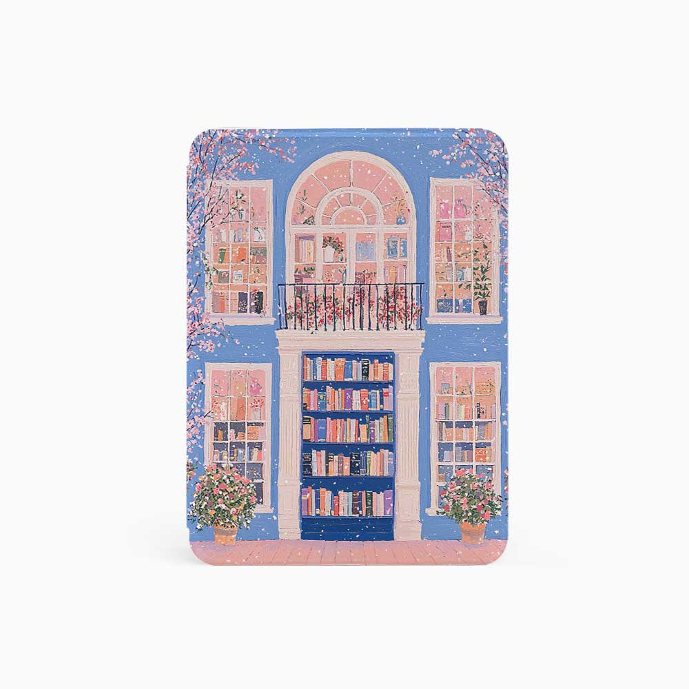A kindle_colorsoft_case design featuring a bookstore with a blue door and an arched window showcasing bookshelves inside. The store has white windows on either side, also displaying books. Two green potted plants sit at the entrance, adding vibrancy. The overall color scheme of blue and pink creates a warm and peaceful atmosphere.