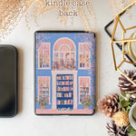 A kindle_colorsoft_case design featuring a bookstore with a blue door and an arched window showcasing bookshelves inside. The store has white windows on either side, also displaying books. Two green potted plants sit at the entrance, adding vibrancy. The overall color scheme of blue and pink creates a warm and peaceful atmosphere.